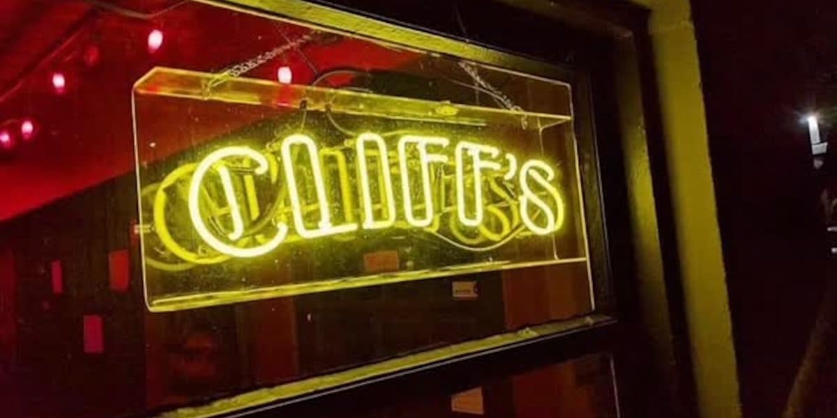 Lit-up sign that says Cliffs in neon yellow