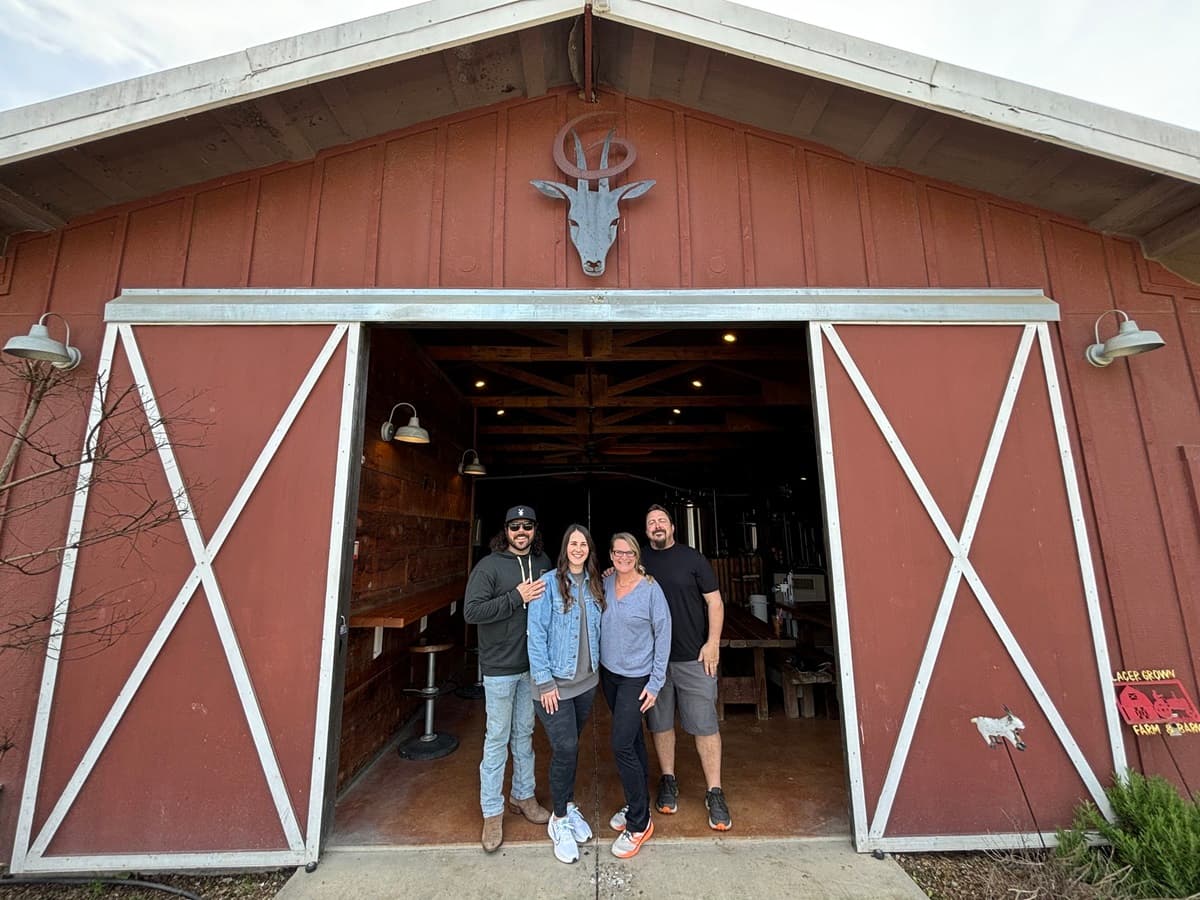 goathouse brewing in lincoln, founder johnsons with new owners mattie and brain place in front of the converted barn